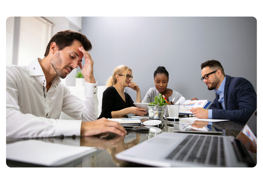 Frustrated team in a meeting doing manual work